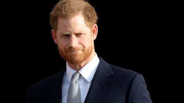 Prince Harry pictured in a navy suit and patterned tie during an event in London, England